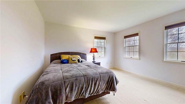 carpeted bedroom with baseboards