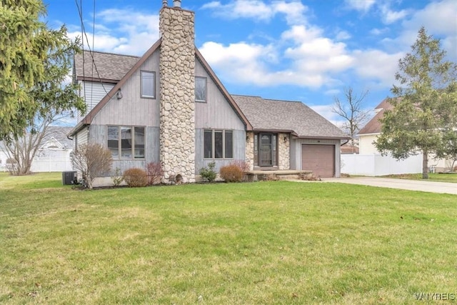 tudor house featuring an attached garage, driveway, fence, and a front lawn