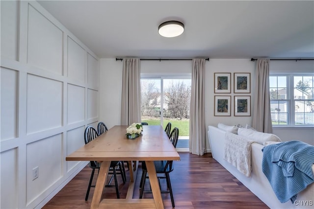 dining space featuring dark wood-style flooring and a wealth of natural light