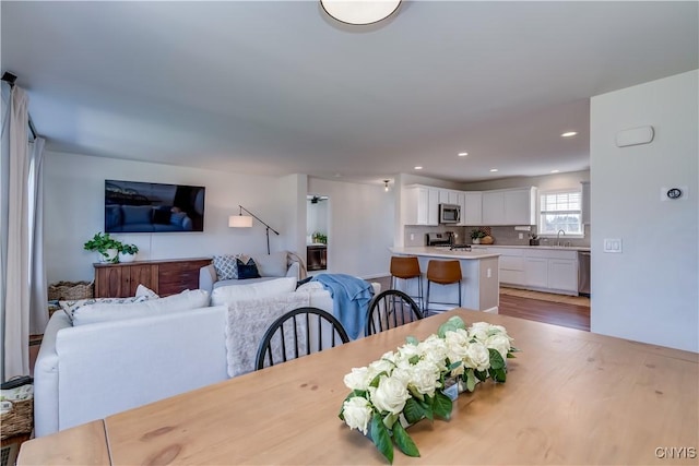 dining space with light wood-style flooring and recessed lighting
