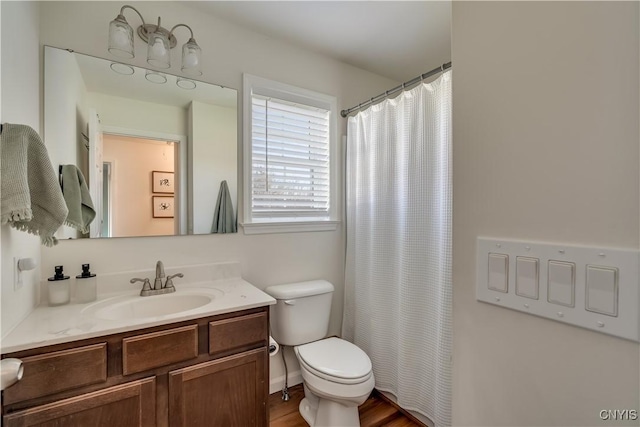 full bath with toilet, wood finished floors, vanity, and a shower with curtain