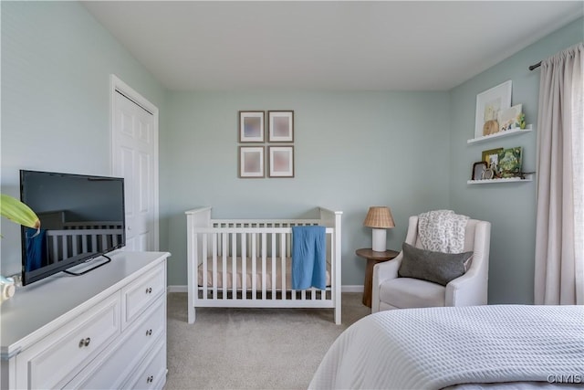 bedroom featuring light colored carpet and baseboards