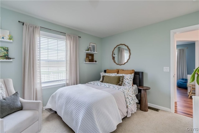 bedroom featuring visible vents, baseboards, and carpet floors