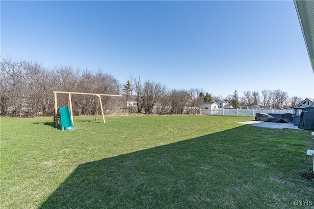 view of yard with fence and a playground