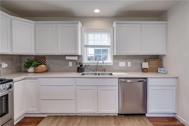 kitchen with light countertops, white cabinetry, a sink, and appliances with stainless steel finishes