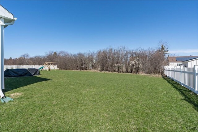 view of yard featuring fence and a playground