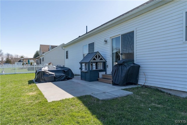 back of house featuring a patio area, fence, and a lawn