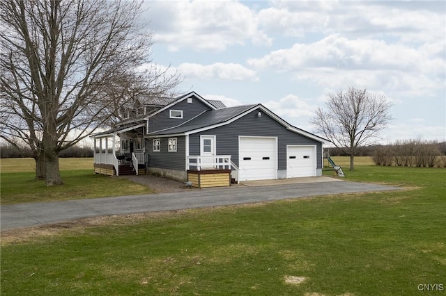13832 County Route 91, Ellisburg, NY 13605 - view of front facade with a front yard, a garage, and aphalt driveway