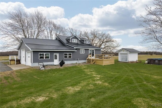 13832 County Route 91, Ellisburg, NY 13605 - rear view of house with metal roof, a deck, an outdoor structure, and a lawn