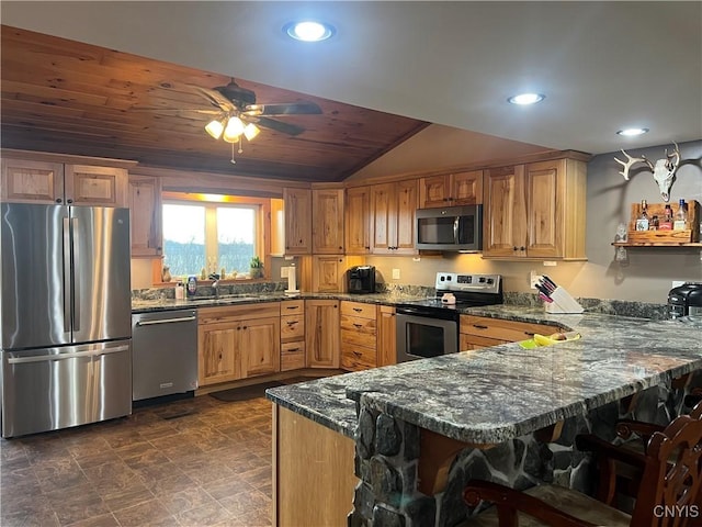 13832 County Route 91, Ellisburg, NY 13605 - kitchen featuring dark stone countertops, a peninsula, a breakfast bar area, appliances with stainless steel finishes, and wooden ceiling