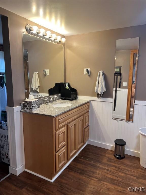 13832 County Route 91, Ellisburg, NY 13605 - bathroom featuring wood finished floors, vanity, and a wainscoted wall