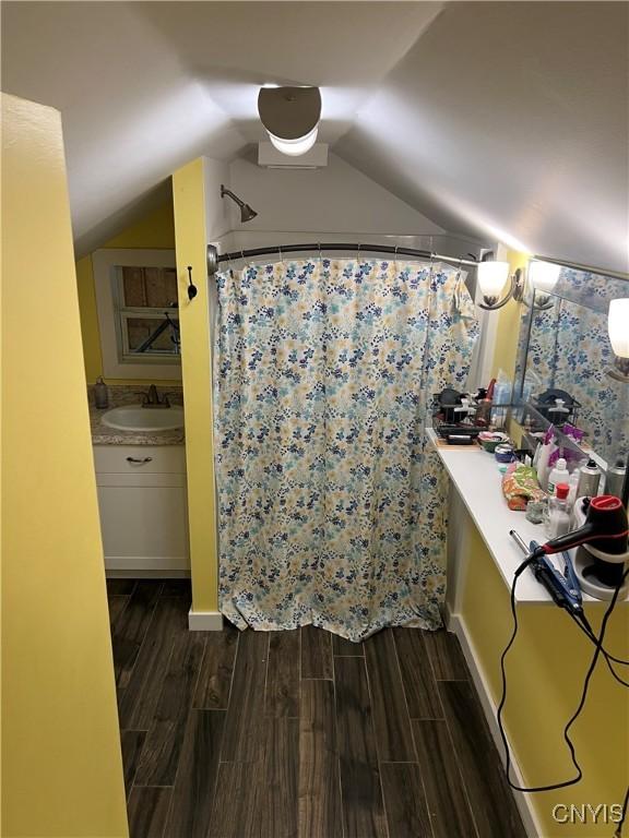 13832 County Route 91, Ellisburg, NY 13605 - bathroom featuring a shower with shower curtain, lofted ceiling, vanity, and wood finished floors