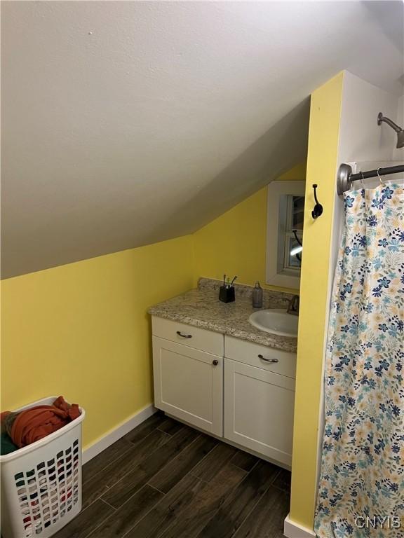 13832 County Route 91, Ellisburg, NY 13605 - full bathroom featuring baseboards, a shower with shower curtain, vanity, wood finished floors, and lofted ceiling