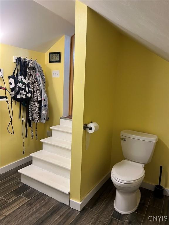 13832 County Route 91, Ellisburg, NY 13605 - bathroom featuring toilet, lofted ceiling, wood finished floors, and baseboards