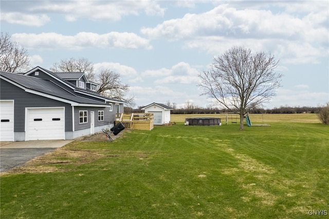 13832 County Route 91, Ellisburg, NY 13605 - view of yard with a storage shed, an attached garage, an outdoor structure, and aphalt driveway