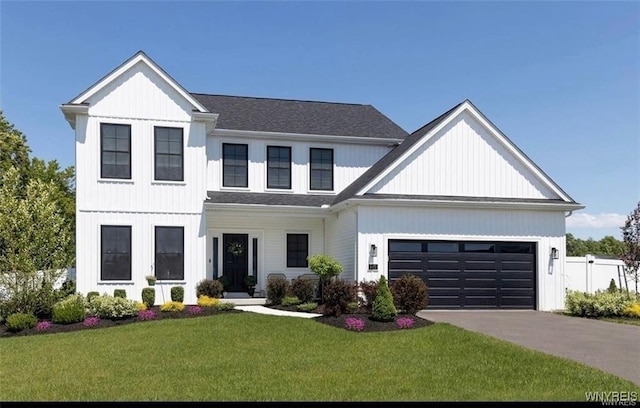modern farmhouse featuring an attached garage, driveway, and board and batten siding