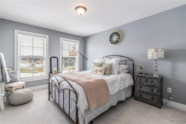 bedroom with baseboards, carpet floors, and multiple windows