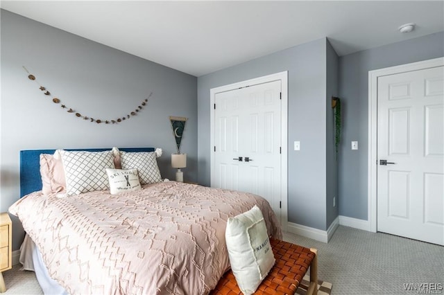 bedroom with carpet floors, a closet, and baseboards
