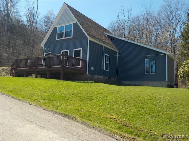 back of house featuring a wooden deck and a lawn