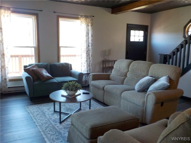 living room with wood finished floors, beam ceiling, and stairway