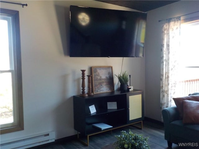 interior space featuring dark wood-style floors and a baseboard heating unit