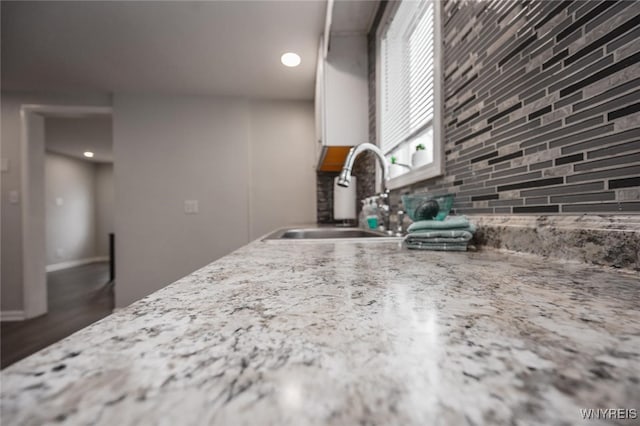 523 76th St, Niagara Falls, NY 14304 - kitchen with light stone counters, a sink, backsplash, and recessed lighting