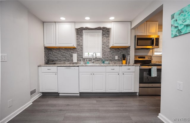 523 76th St, Niagara Falls, NY 14304 - kitchen featuring a sink, appliances with stainless steel finishes, white cabinets, and tasteful backsplash