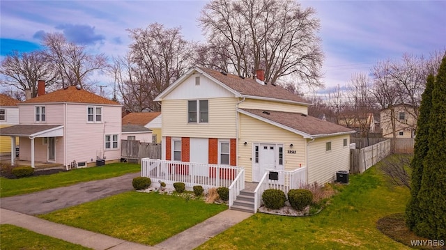 523 76th St, Niagara Falls, NY 14304 - traditional-style home with fence, central air condition unit, a front lawn, and a wooden deck