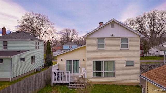 523 76th St, Niagara Falls, NY 14304 - back of house featuring central air condition unit, a deck, fence, and a chimney