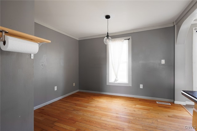15-17A Vincent St, Champion, NY 13619 - unfurnished dining area featuring crown molding, light wood-type flooring, arched walkways, visible vents, and baseboards