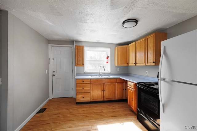 15-17A Vincent St, Champion, NY 13619 - kitchen featuring freestanding refrigerator, electric range, a sink, light countertops, and light wood finished floors
