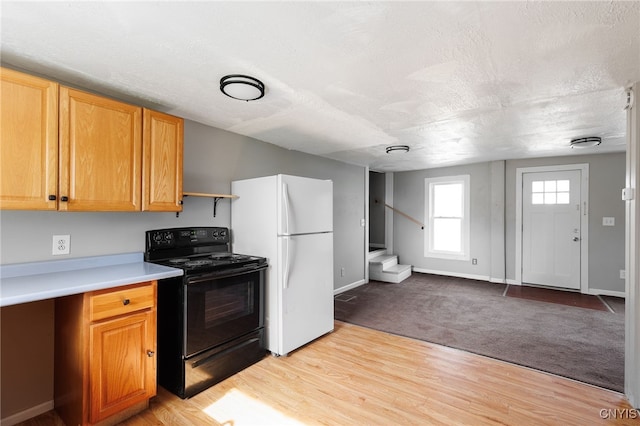 15-17A Vincent St, Champion, NY 13619 - kitchen featuring freestanding refrigerator, light wood-style flooring, a textured ceiling, light countertops, and black electric range oven