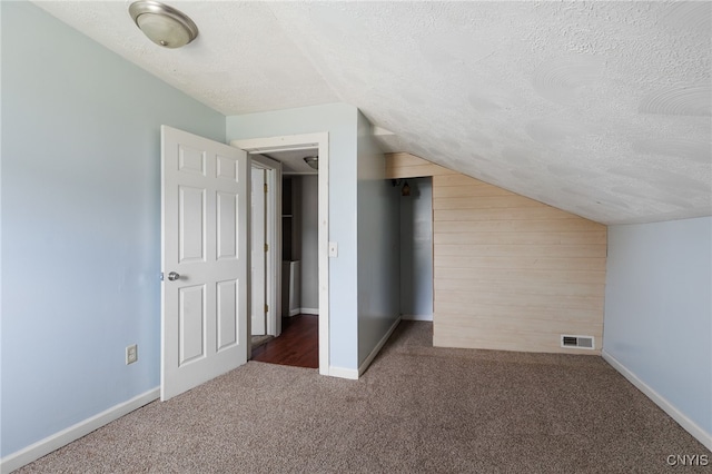 15-17A Vincent St, Champion, NY 13619 - additional living space featuring carpet, a textured ceiling, vaulted ceiling, visible vents, and baseboards