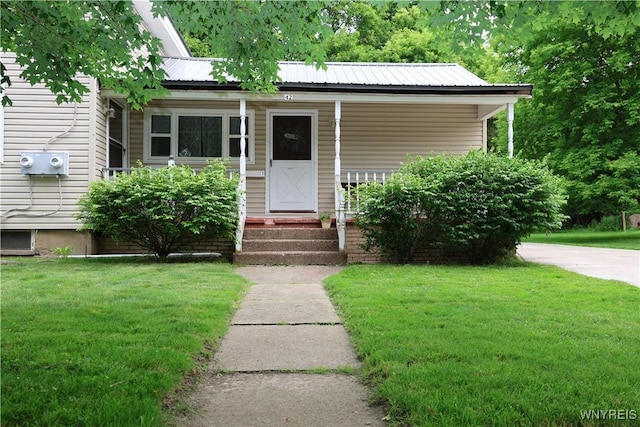 42 Mechanic St, Collins, NY 14070 - view of front facade with a front lawn, covered porch, and a metal roof