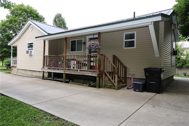 42 Mechanic St, Collins, NY 14070 - rear view of house with a metal roof and covered porch