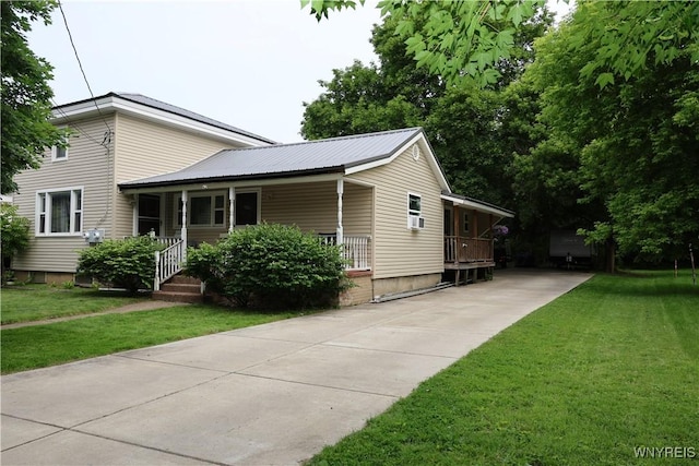 42 Mechanic St, Collins, NY 14070 - view of front facade featuring concrete driveway, a front lawn, a porch, and cooling unit