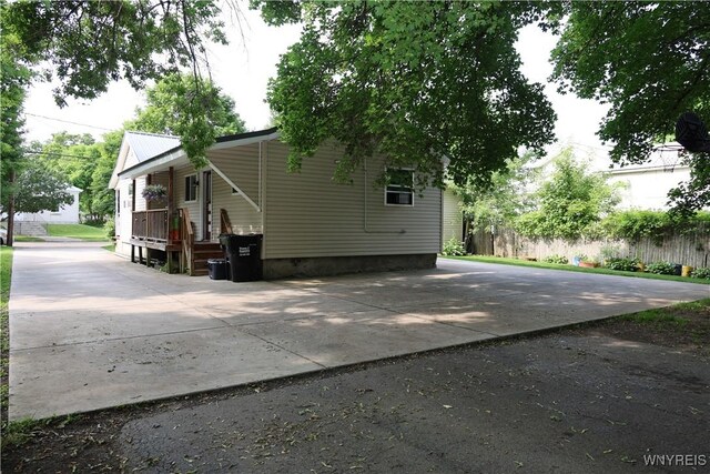 42 Mechanic St, Collins, NY 14070 - view of side of property with covered porch, crawl space, and concrete driveway