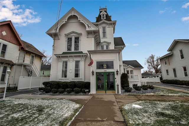 view of front of property featuring french doors and fence