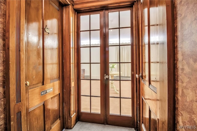 entryway featuring french doors and carpet flooring