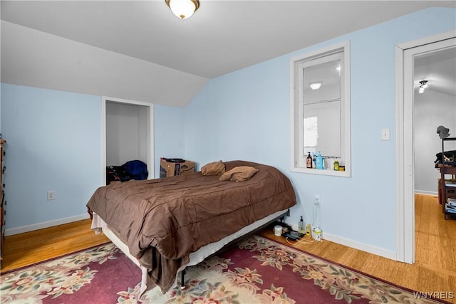11400 Savage Rd, Sardinia, NY 14030 - bedroom with wood finished floors, vaulted ceiling, and baseboards