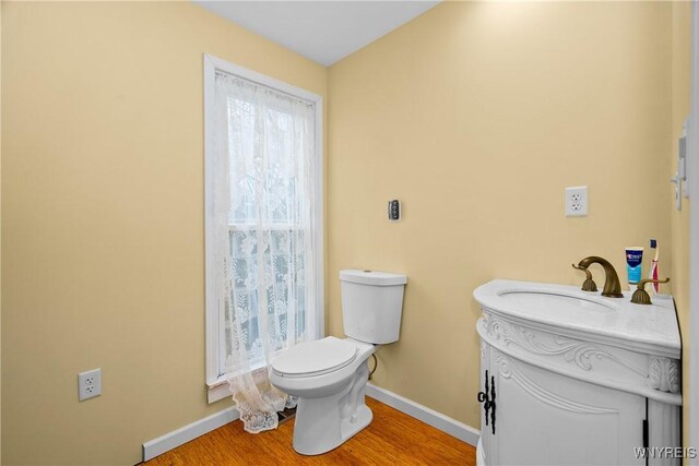 11400 Savage Rd, Sardinia, NY 14030 - bathroom with toilet, baseboards, vanity, and wood finished floors