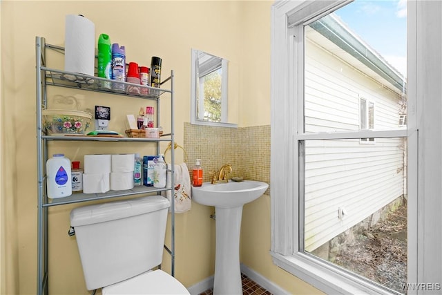 11400 Savage Rd, Sardinia, NY 14030 - half bath featuring toilet, tile walls, a wainscoted wall, and a sink