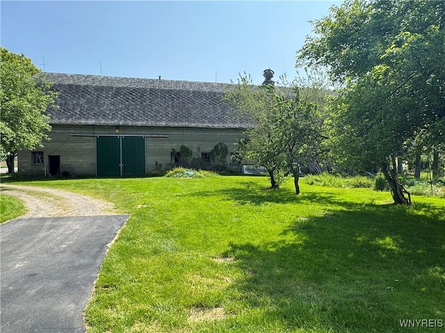 11400 Savage Rd, Sardinia, NY 14030 - view of green lawn with driveway, an outdoor structure, and a barn