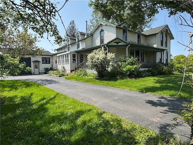 11400 Savage Rd, Sardinia, NY 14030 - view of front of house featuring a front yard, driveway, covered porch, and an attached garage