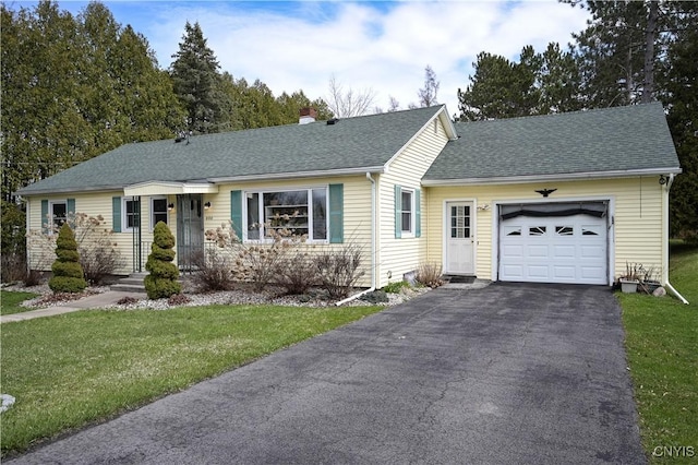 ranch-style home with a garage, a front yard, a chimney, a shingled roof, and driveway