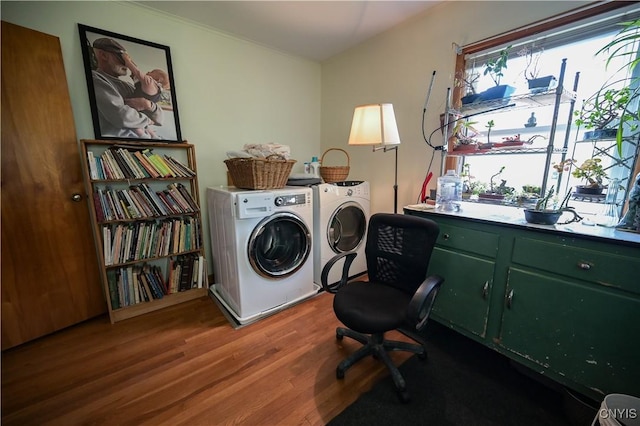laundry area with cabinet space, washing machine and dryer, and wood finished floors