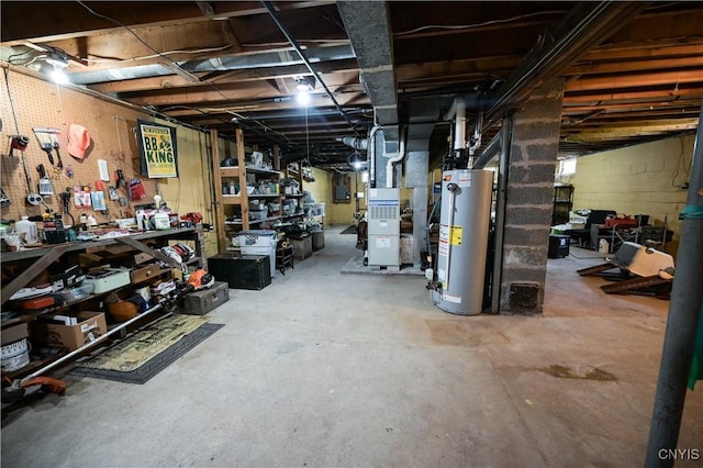 unfinished basement with heating unit, a workshop area, and gas water heater