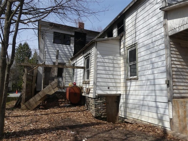view of property exterior featuring a chimney