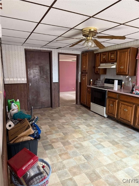 525 Bell Hill Rd, German Flatts, NY 13357 - kitchen featuring a paneled ceiling, under cabinet range hood, wainscoting, and electric stove