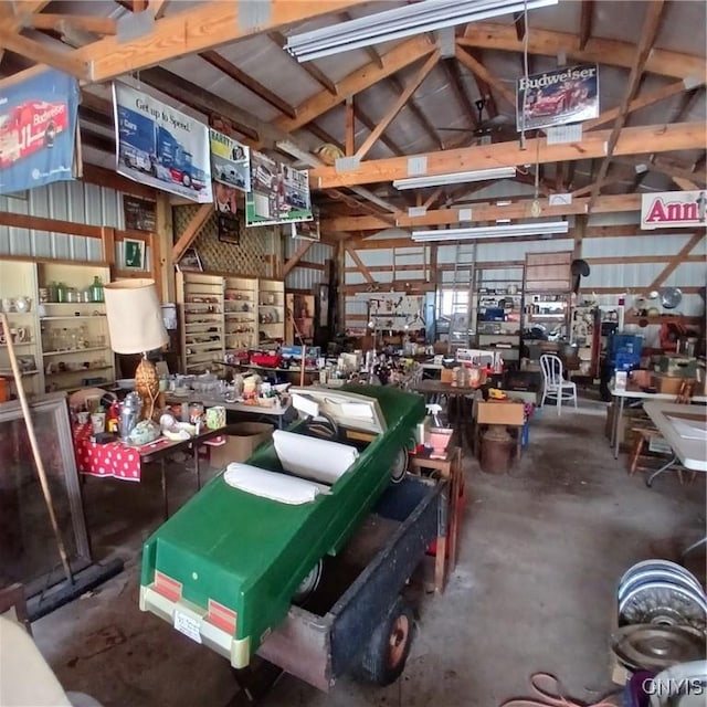 654 Water St, Watertown-City, NY 13601 - interior space featuring a garage, unfinished concrete flooring, a workshop area, and vaulted ceiling